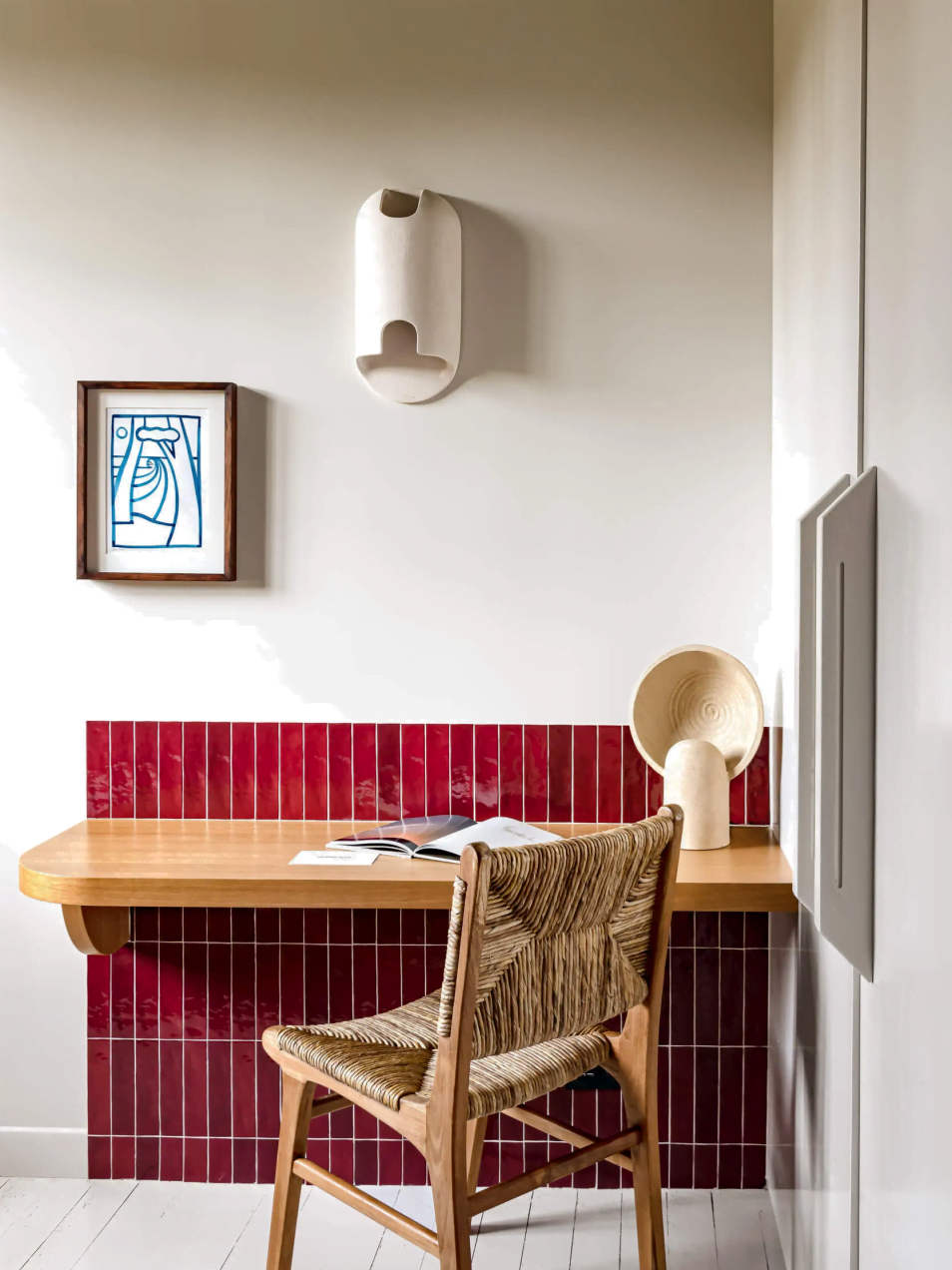 Close up on the working area, reddish tiles on the walls and wood chair at Les Bords du Lac
