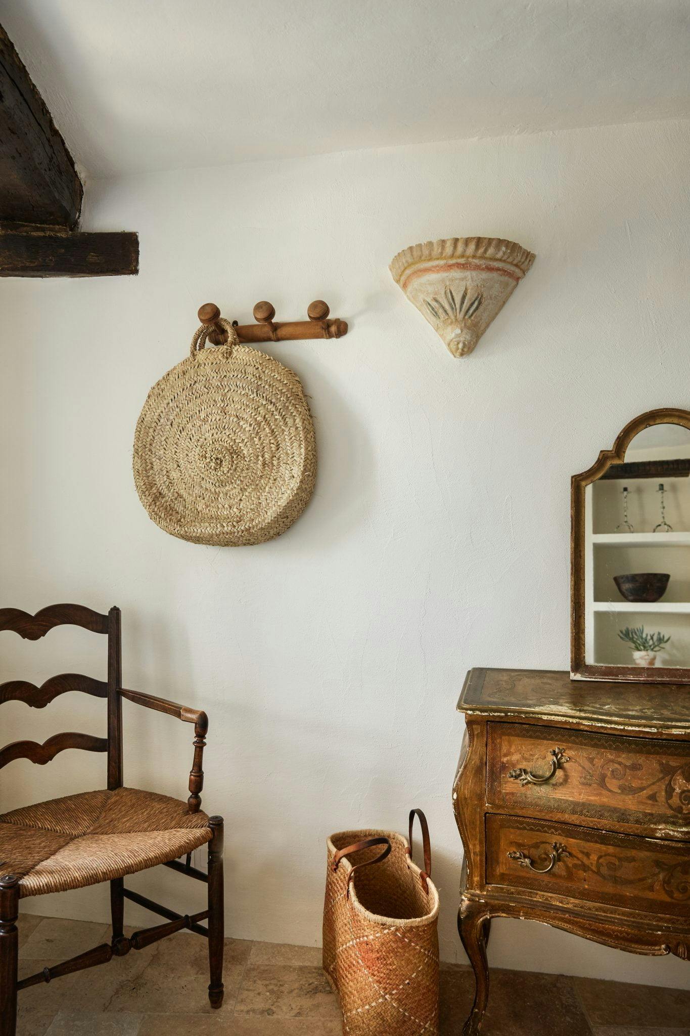 Bedroom detail: antique order, market basket and straw chair