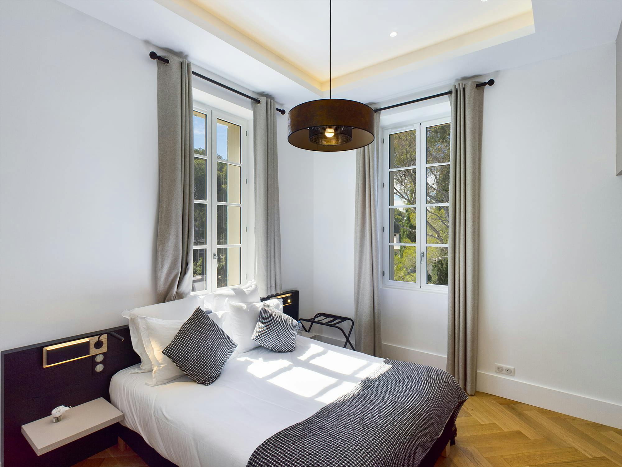 Sunny bedroom, hanging lamp and view of the château garden