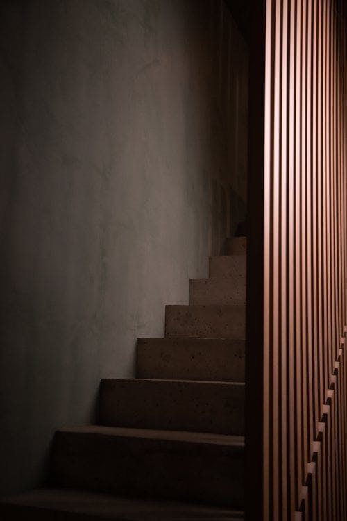 staircase with vertical wooden railing