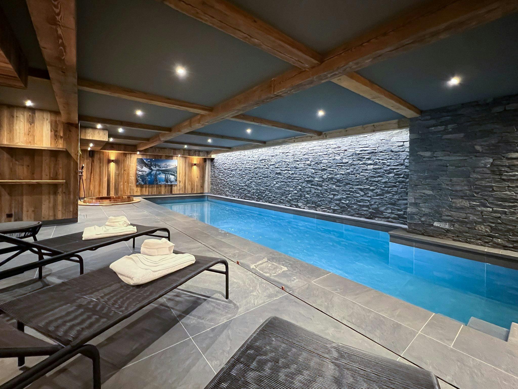 large indoor swimming pool with sun loungers