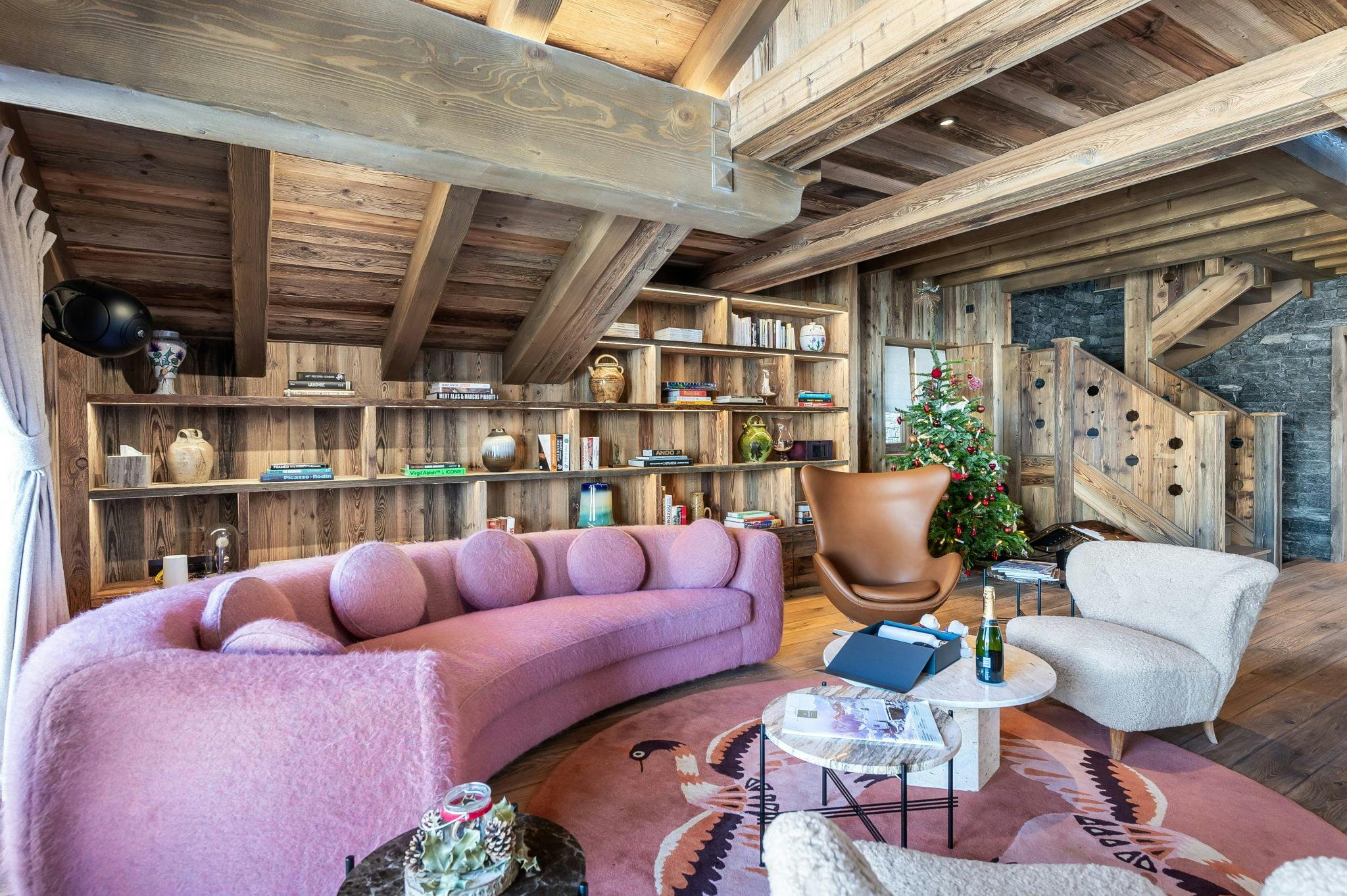 wooden lounge, pink sofa and large library