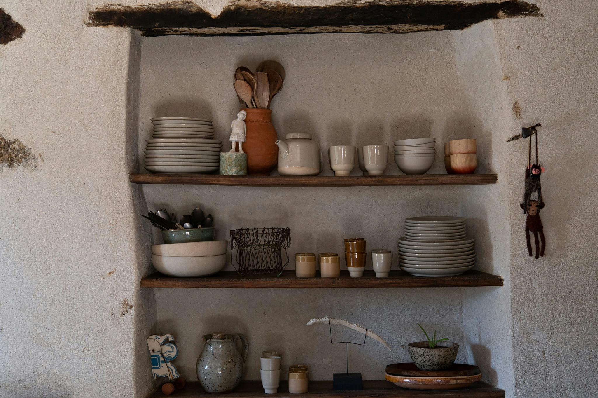 shelf with crockery and kitchen utensils