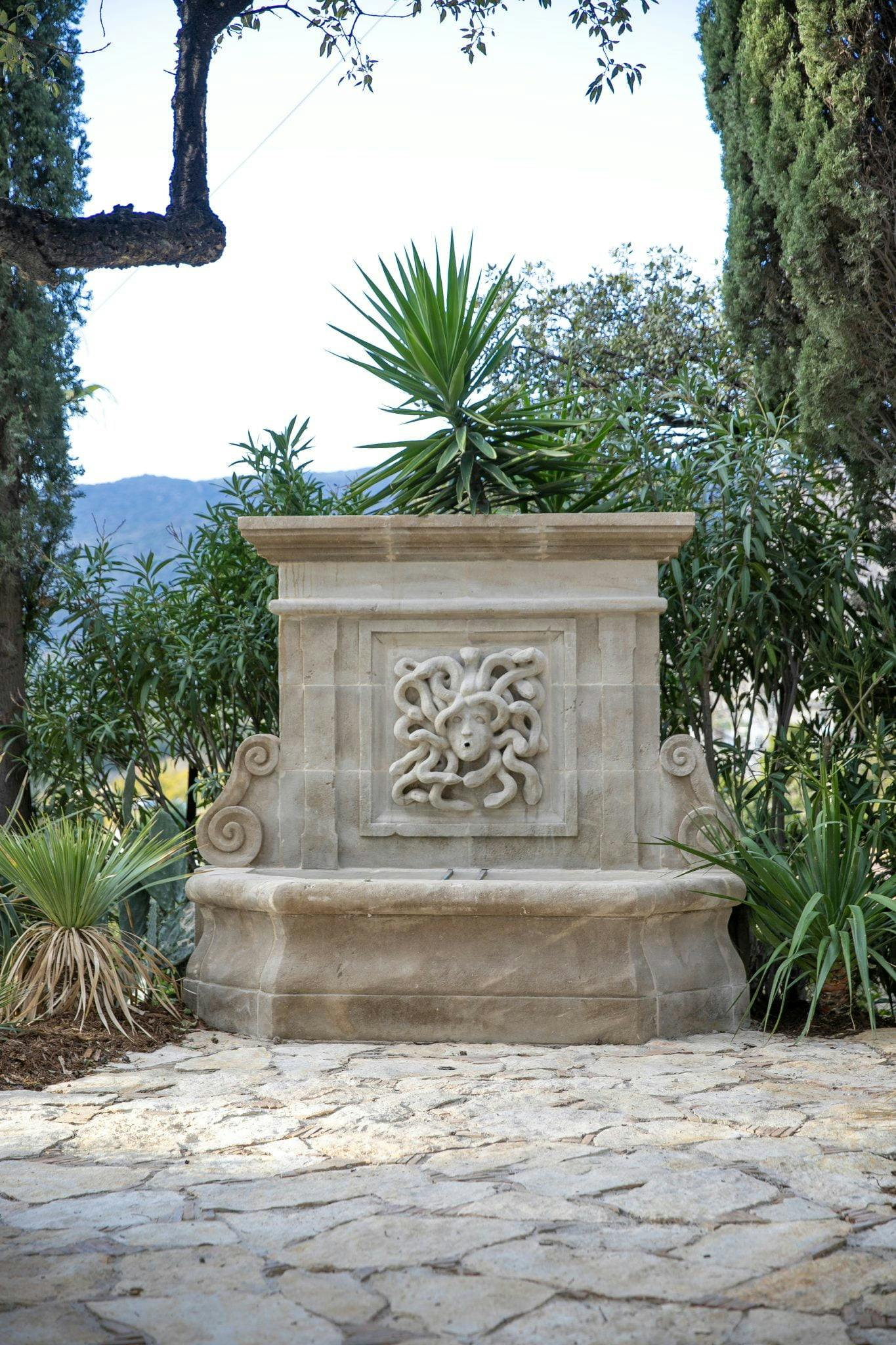 Original stone fountain in the garden with octopus