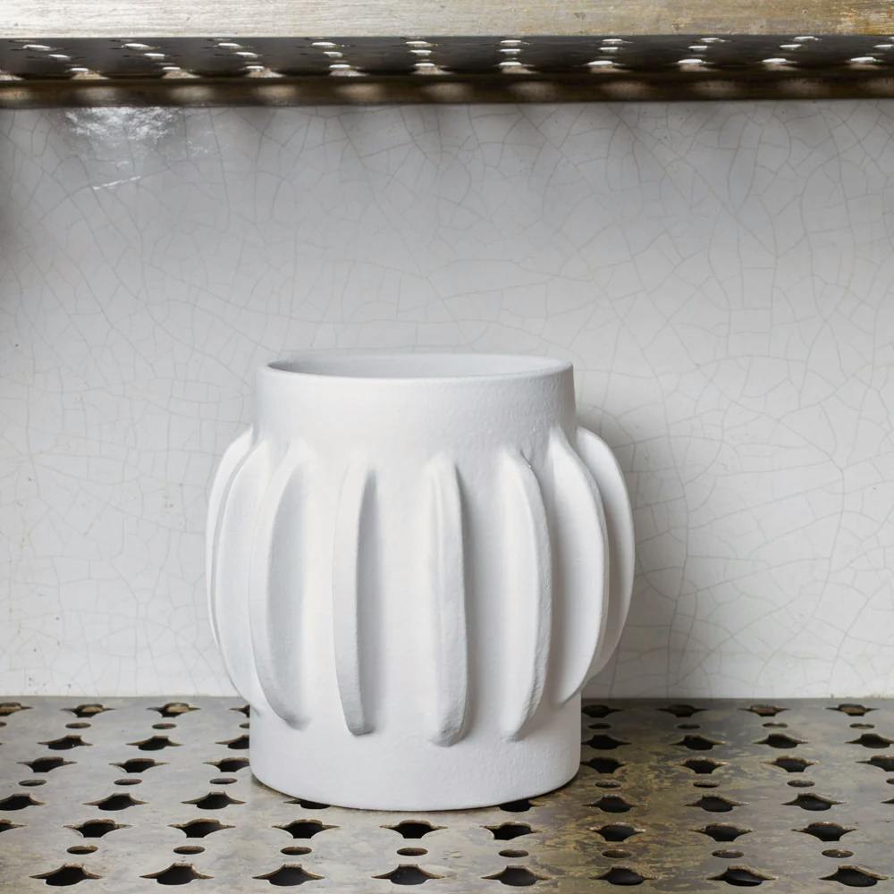 packshot white vase on an industrial shelf