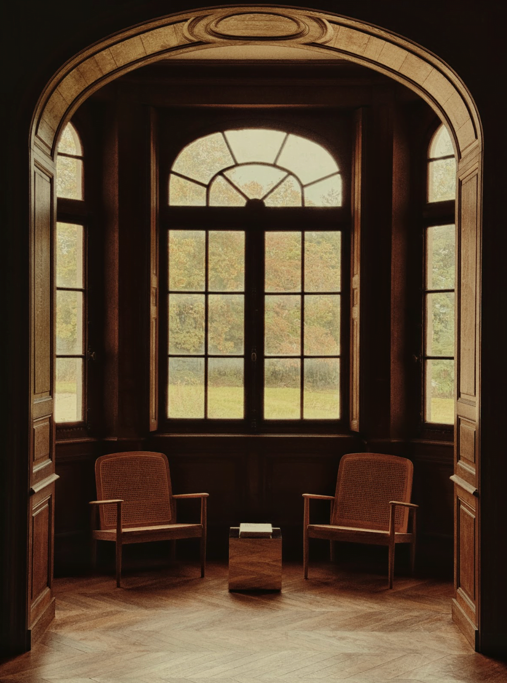 View of a cozy reading nook at Château de Thauvenay: armchairs in front of the windows