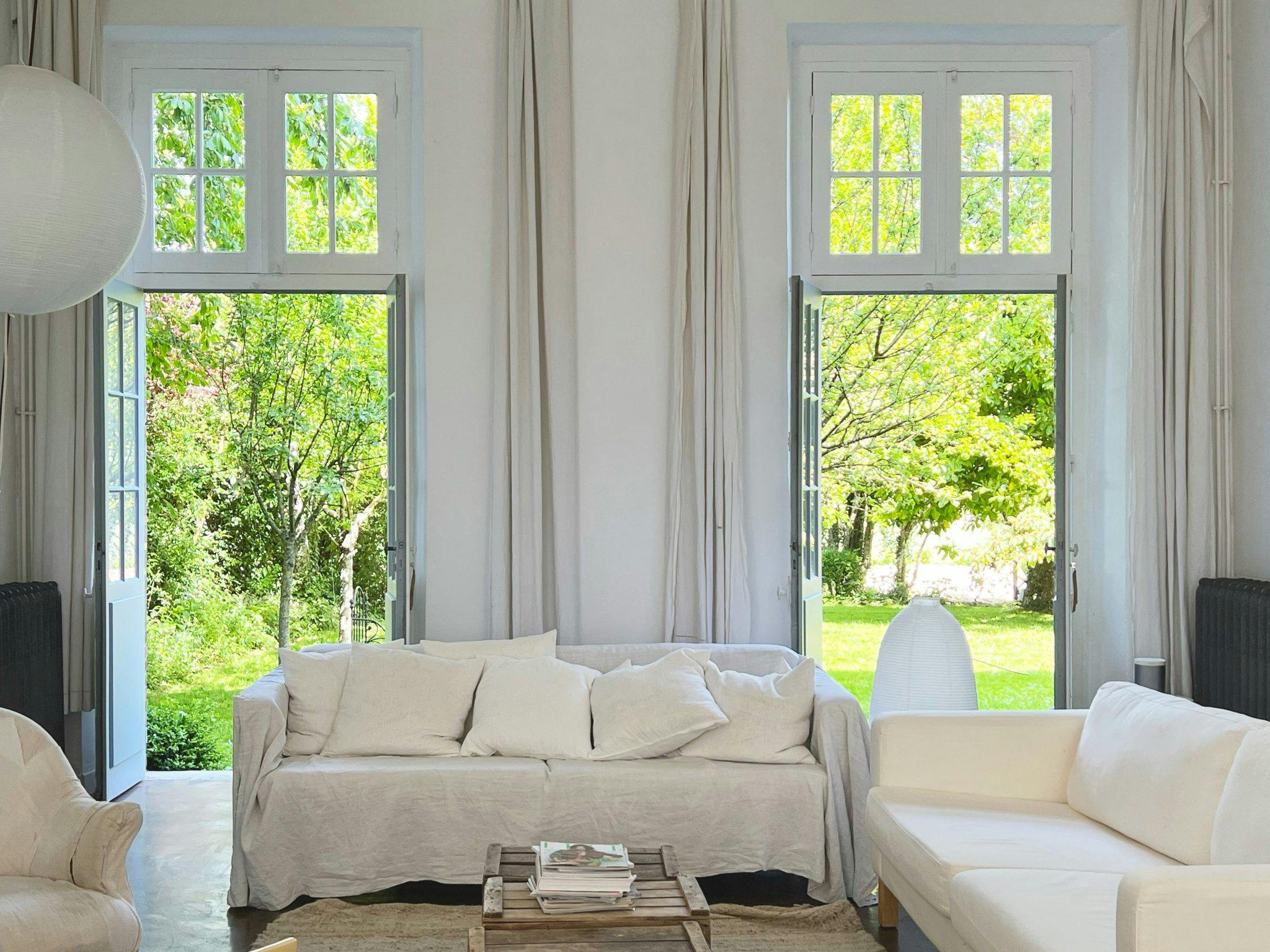 The living room of the Couvent des Ormes, 3 white couches