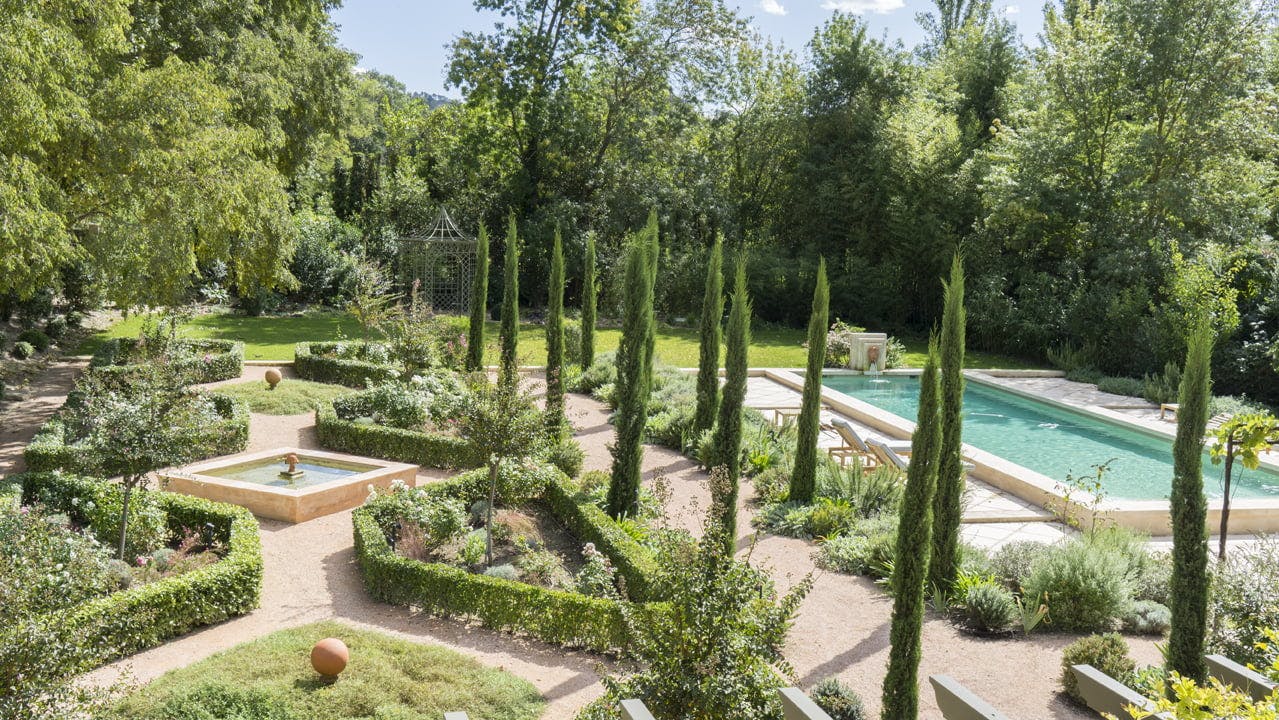 One of the French gardens at Mas le Gaudre: cypress trees, bushes, trees