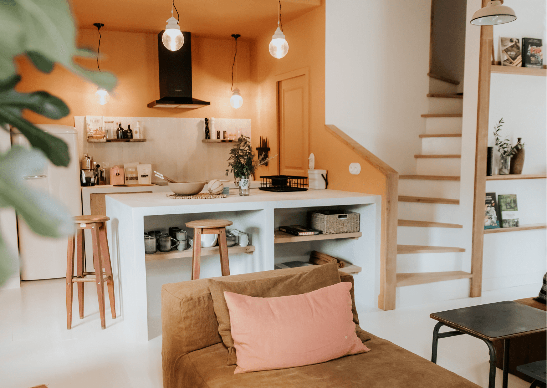 The barn's living room-kitchen: table, armchair