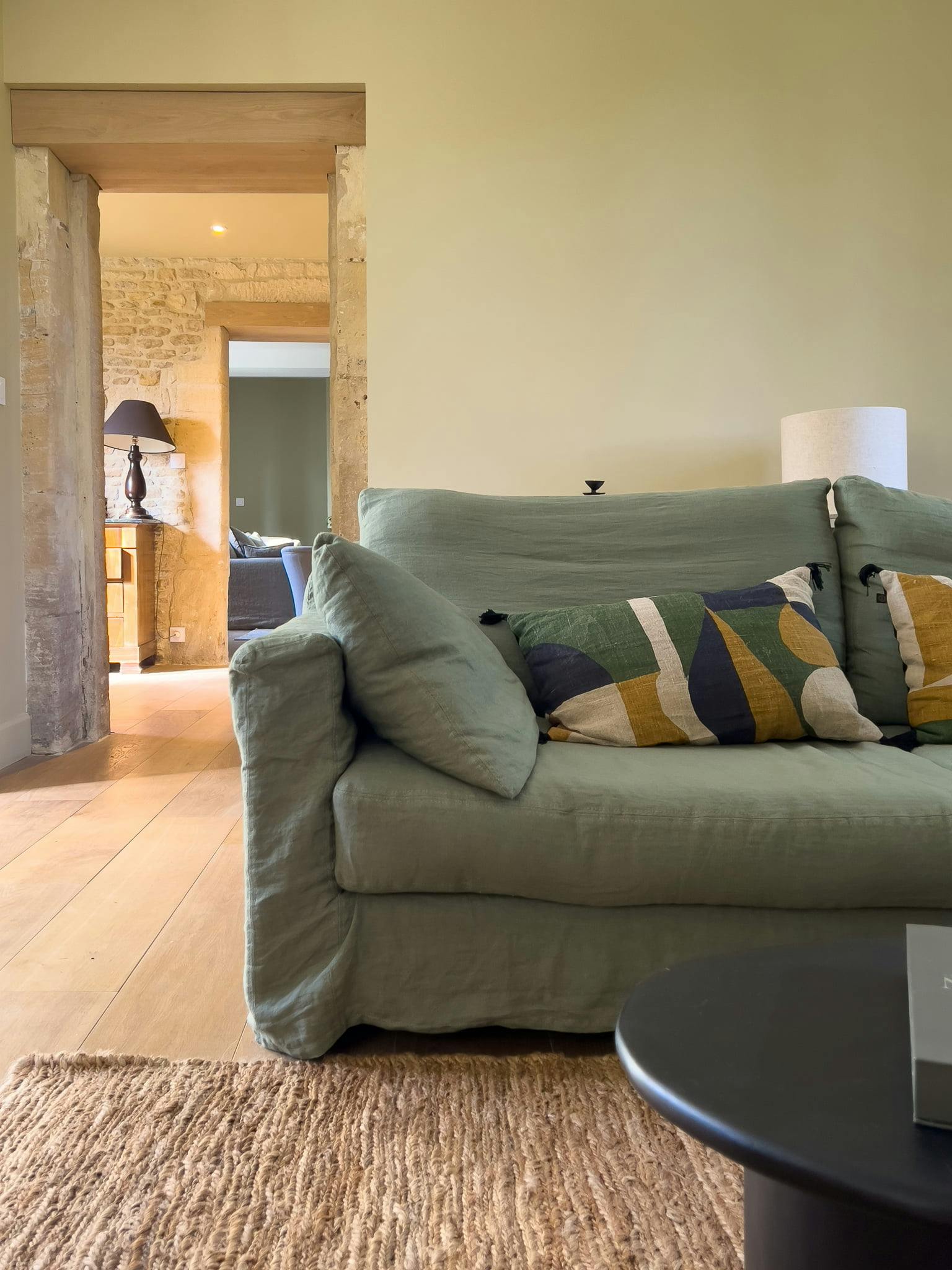 Khaki green sofa in one of the lounges, with a glossy black coffee table.