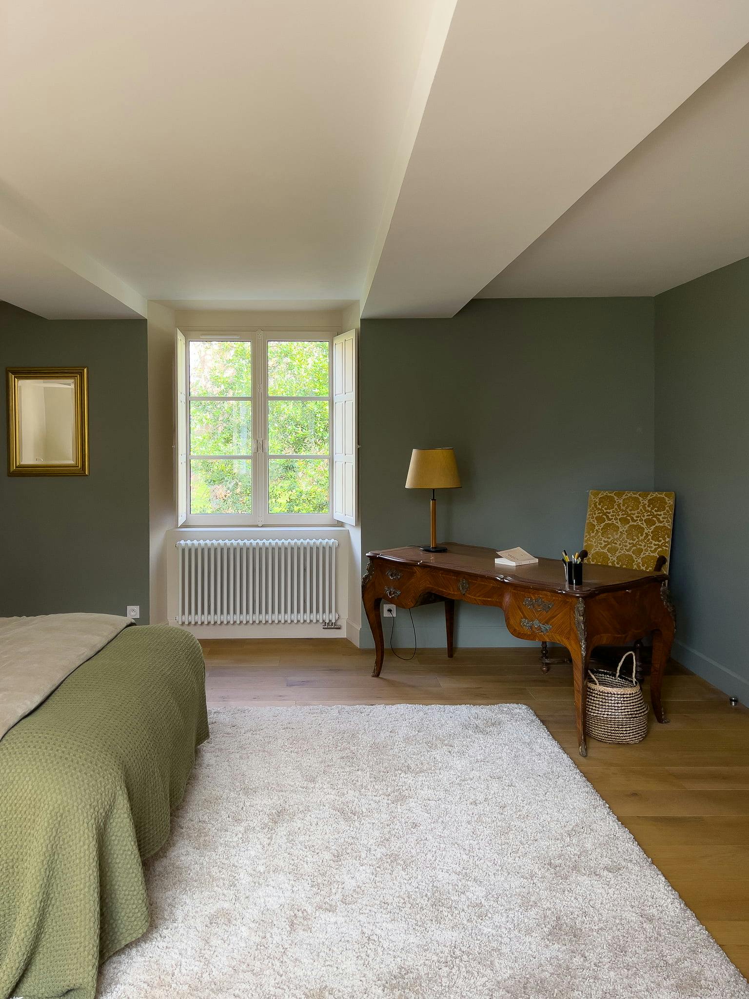 One of the rooms in the château: white carpet, wooden desk.