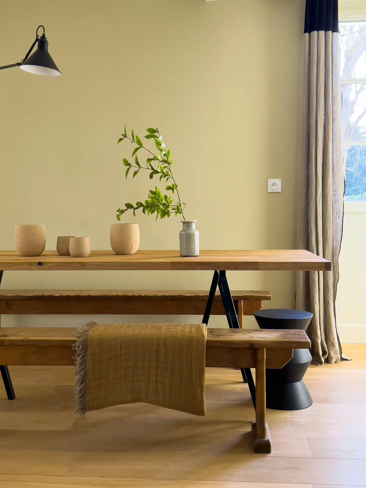 The wooden dining table, chairs, and vases