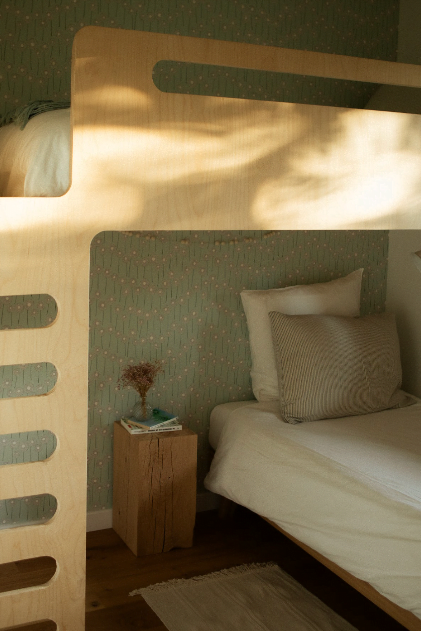 A loft bed and a regular bed in one of the rooms