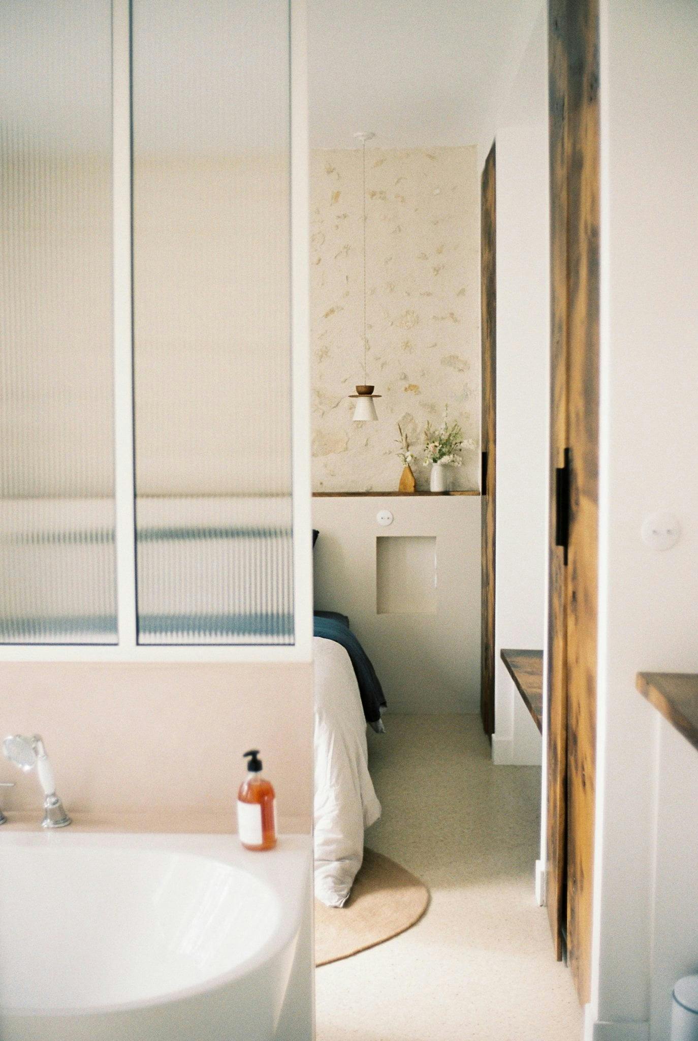 French window between the bedroom and the bathroom