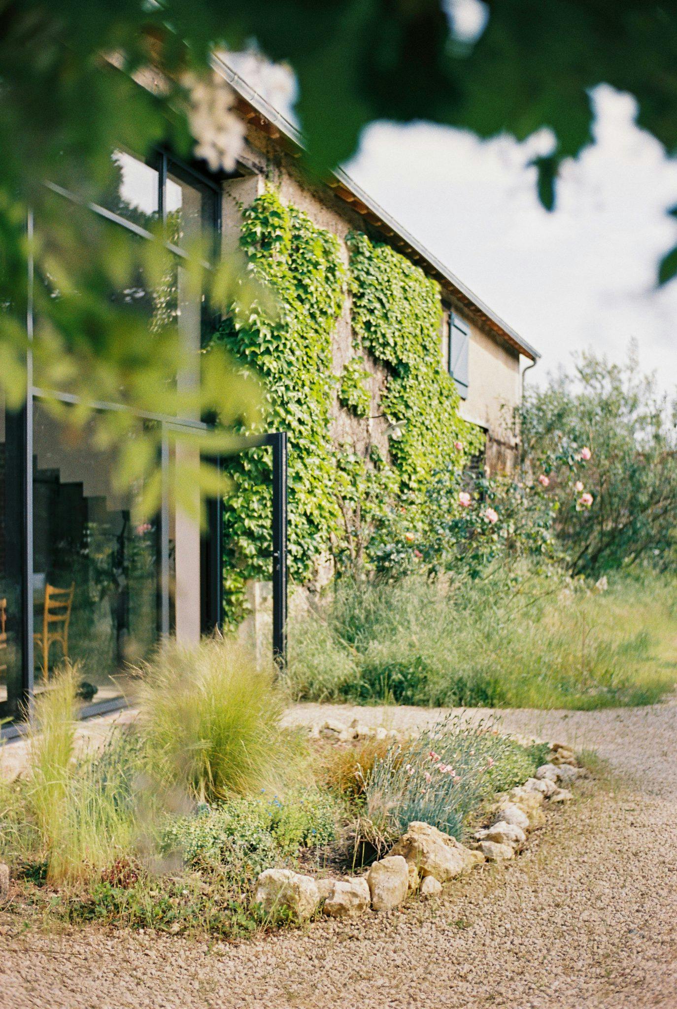 The facade of the house: stone walls, ivy