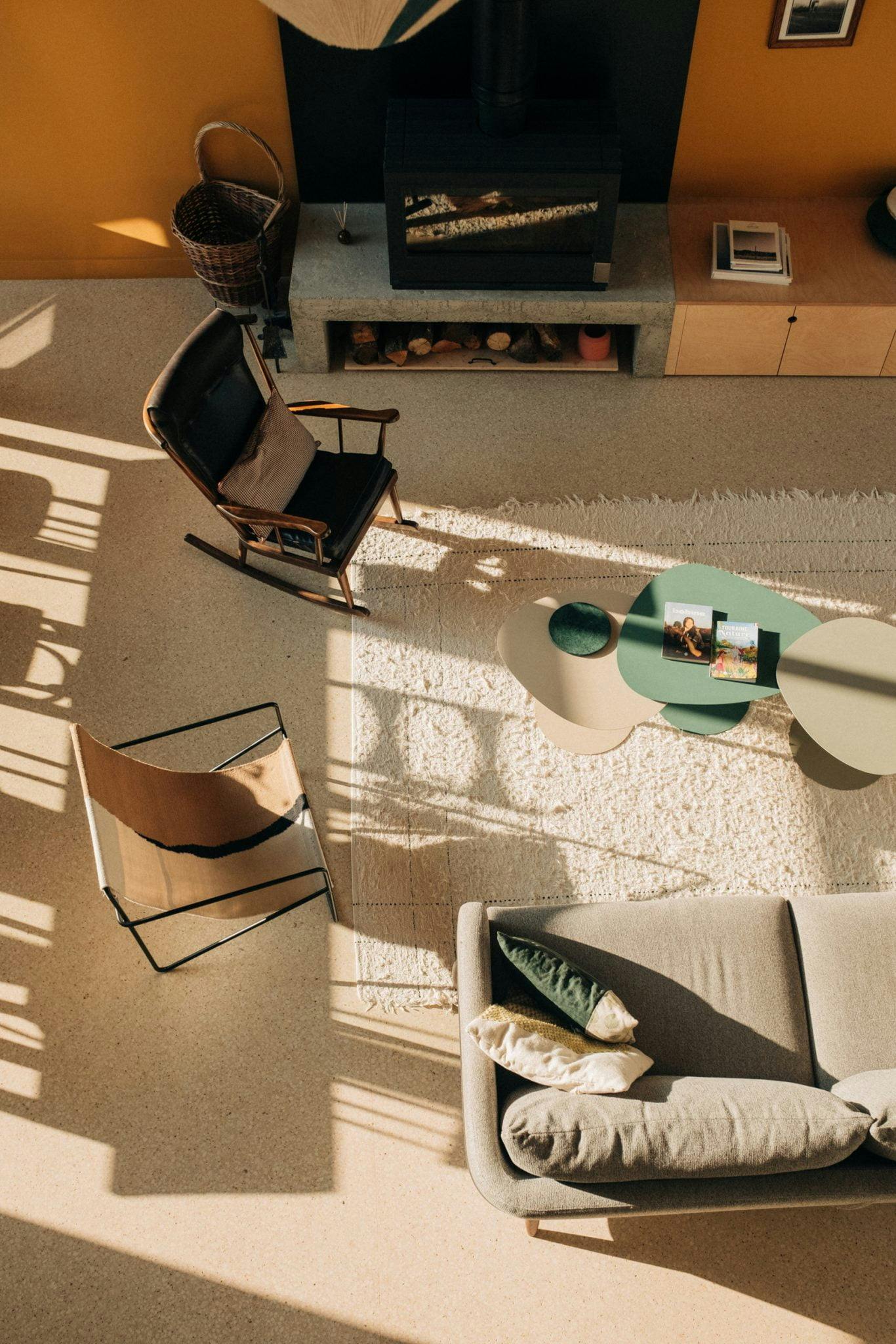 The living room seen from the upstairs: armchairs, sofa, coffee table