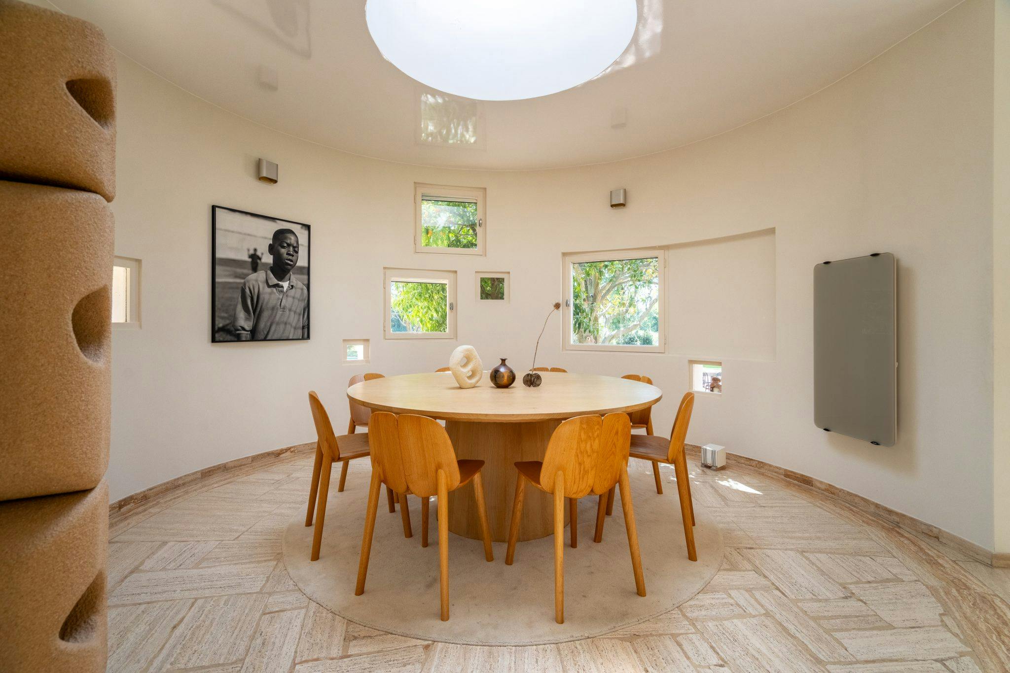 Salle à manger circulaire : table ronde, chaises, suspension