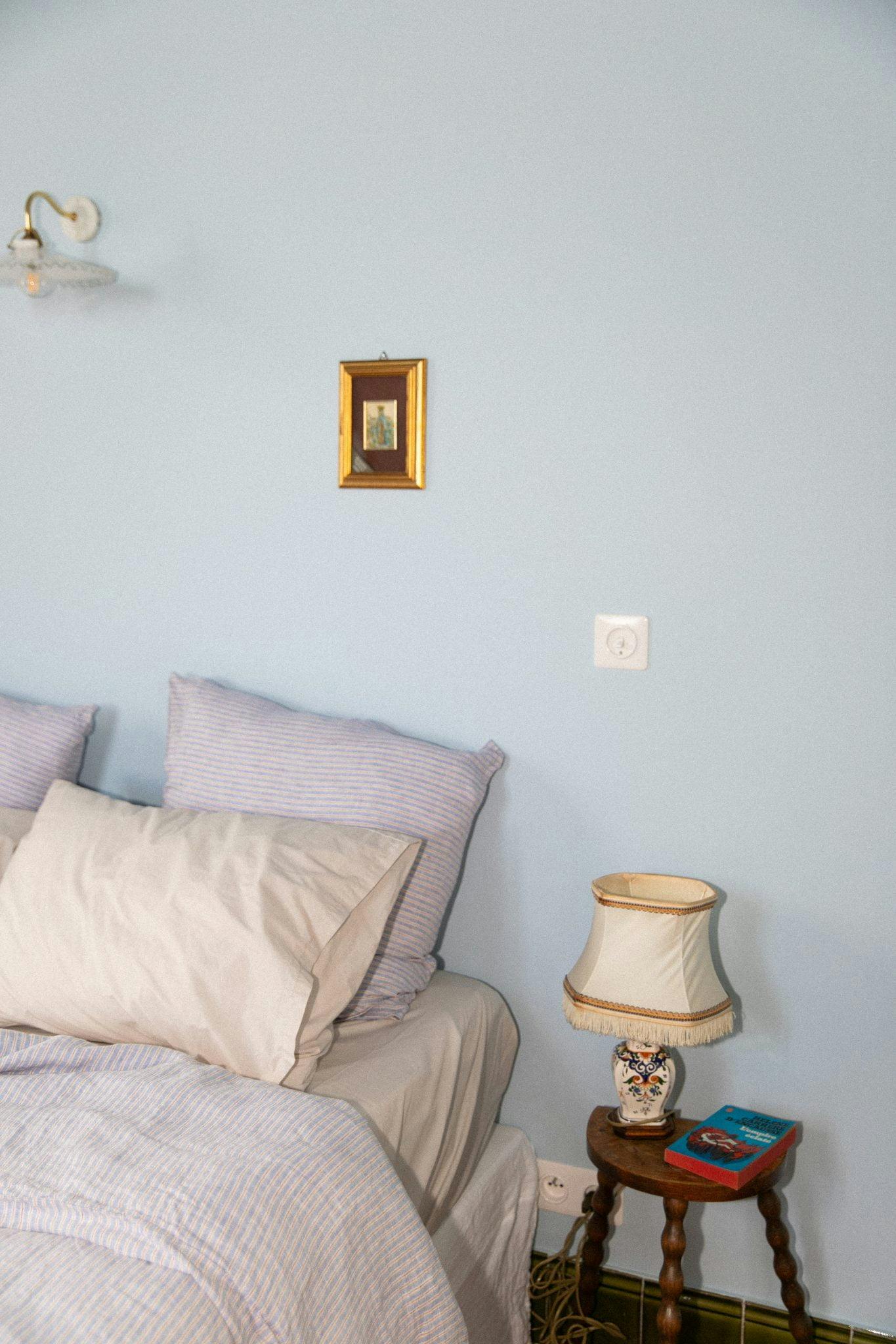 The blue bedroom: double bed, nightstand, lamp