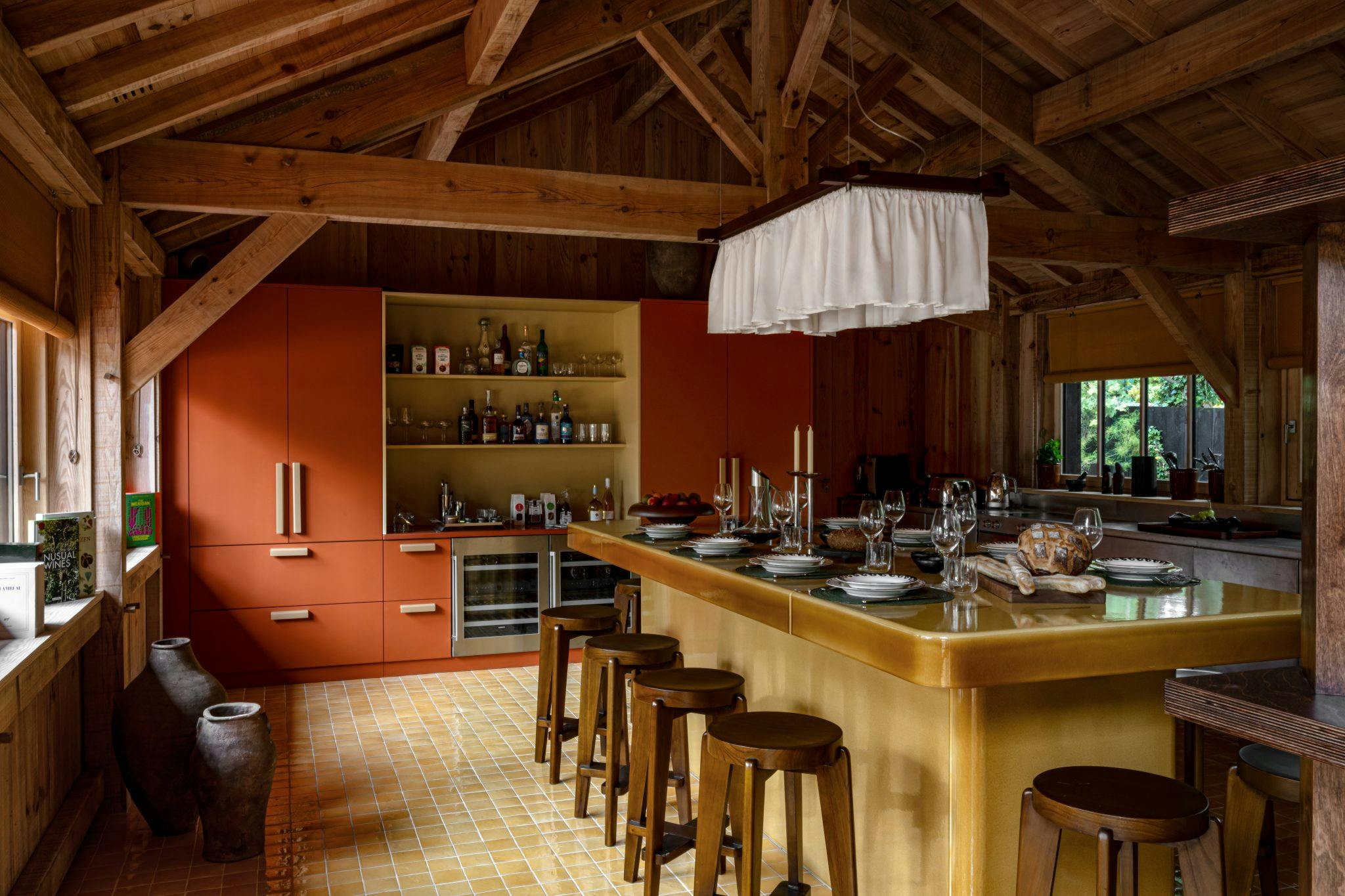 The large dining table in the kitchen, fabric pendant light