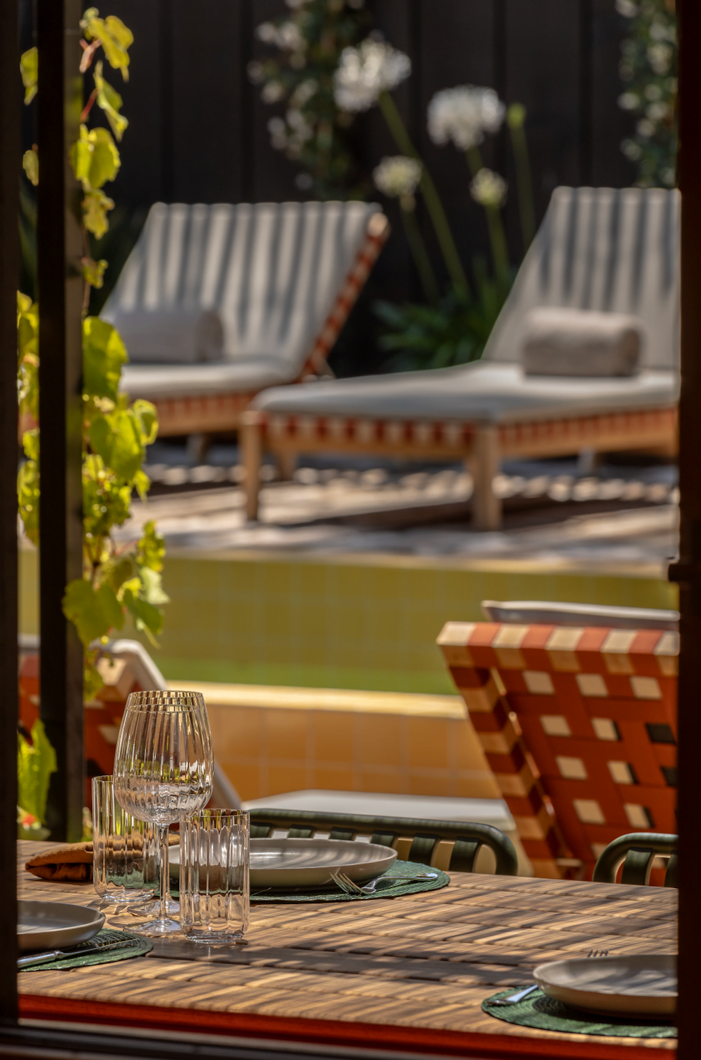 Lounge chairs by the poolside in the garden