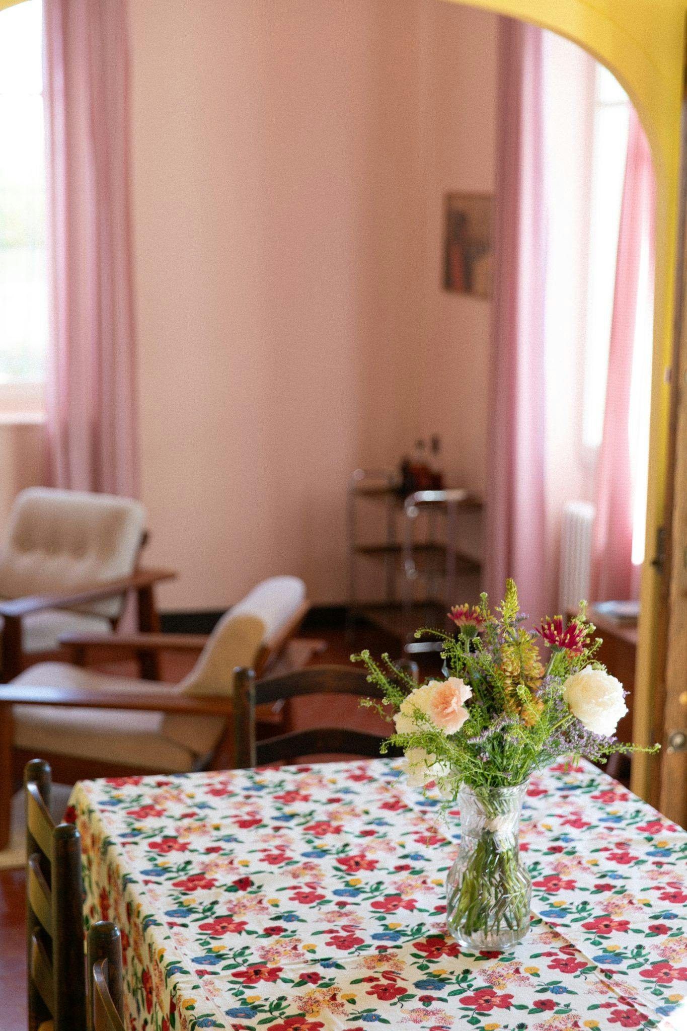 Bouquet of flowers on the dining room table, floral tablecloth