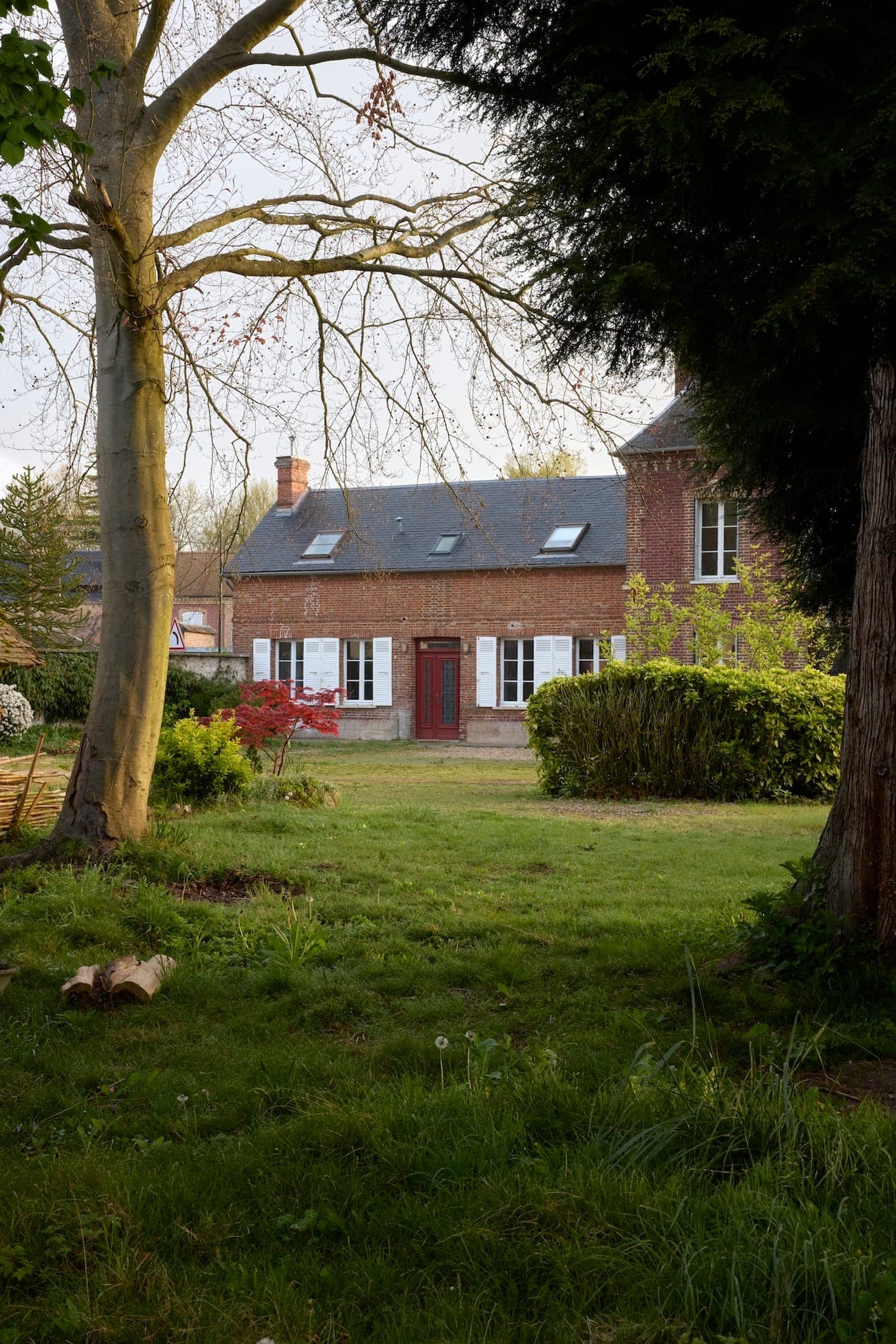 At the heart of a lush garden stands the charming brick house.