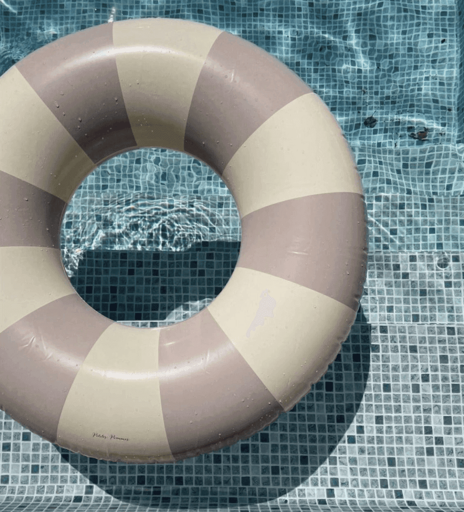 Bouée à rayures mauves et blanches dans une piscine 