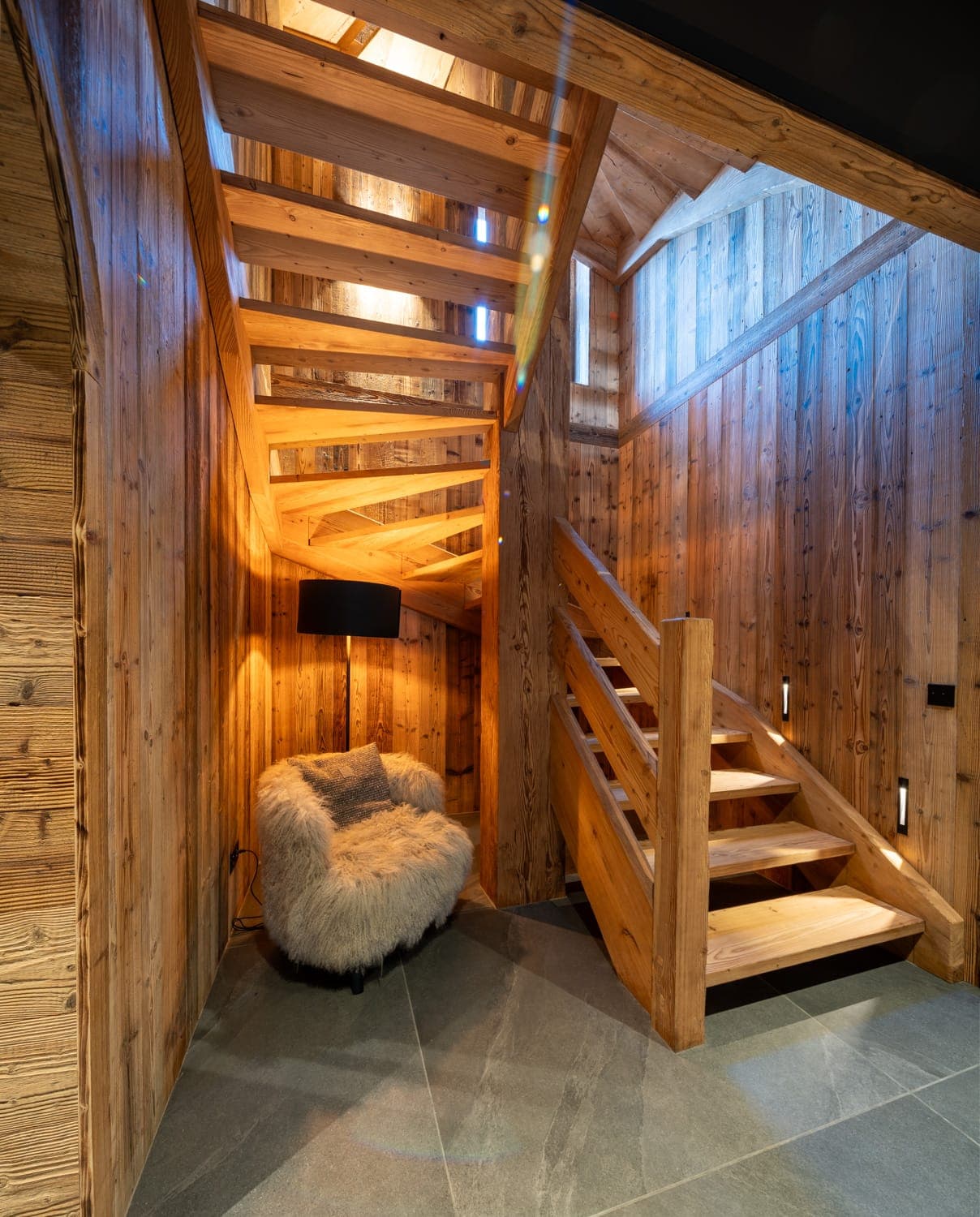 A cozy reading nook under the staircase.