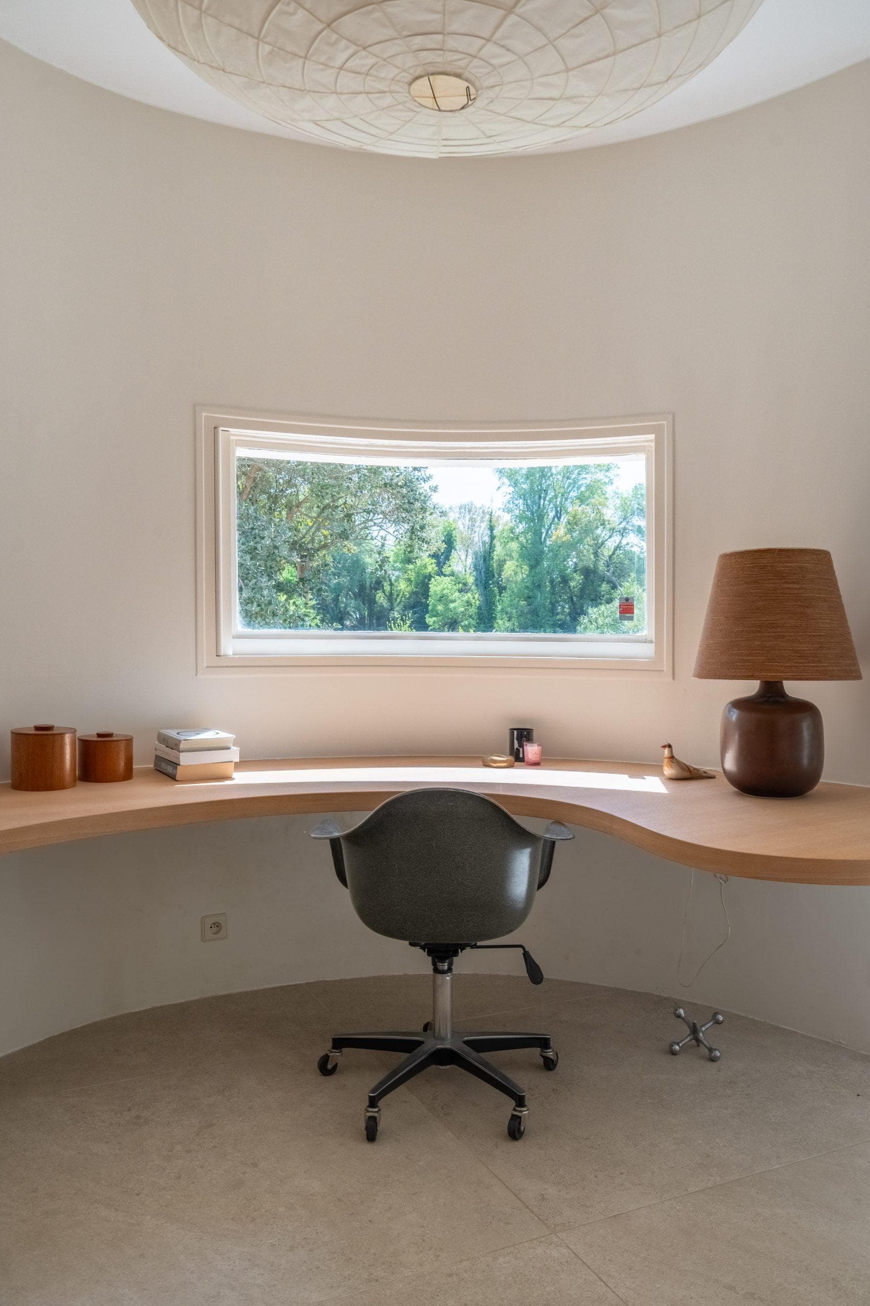 Desk facing the window, chair, pendant light