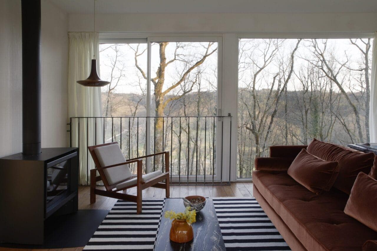 The living room of Les Grands Chênes with a view of the oak grove.