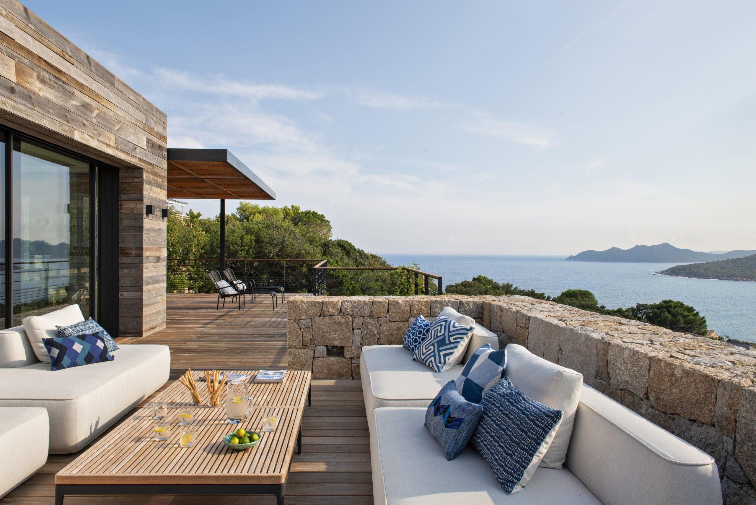 wooden terrace with stone railings, sea views from the sofas in the villa