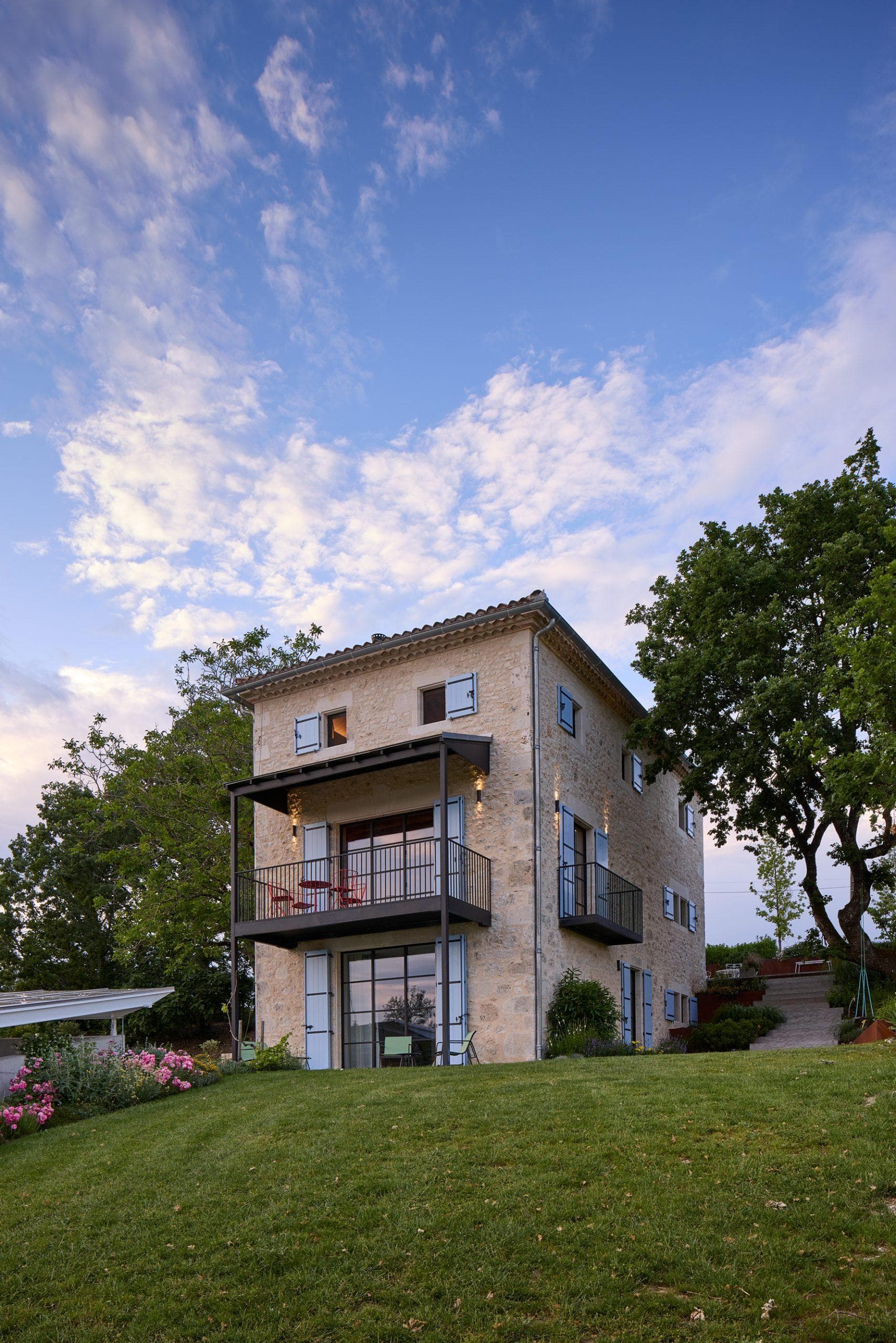 The main house near the pool with solar panels